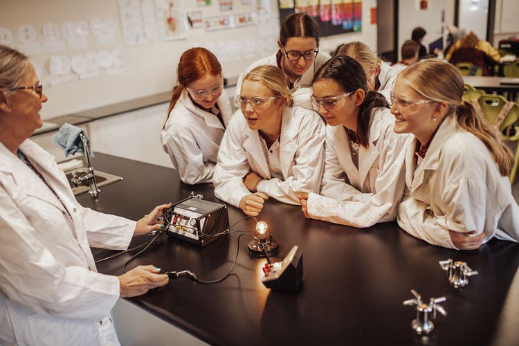 Students and teacher conducting science experiment