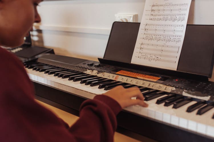 Student playing an piano organ