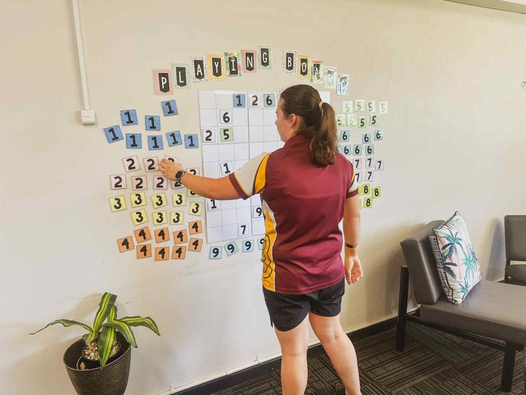 Student in wellbeing room playing game on wall